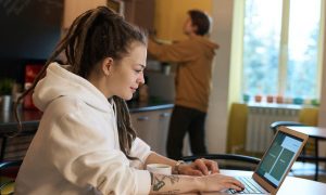 Woman working in a coffee shop on her computer